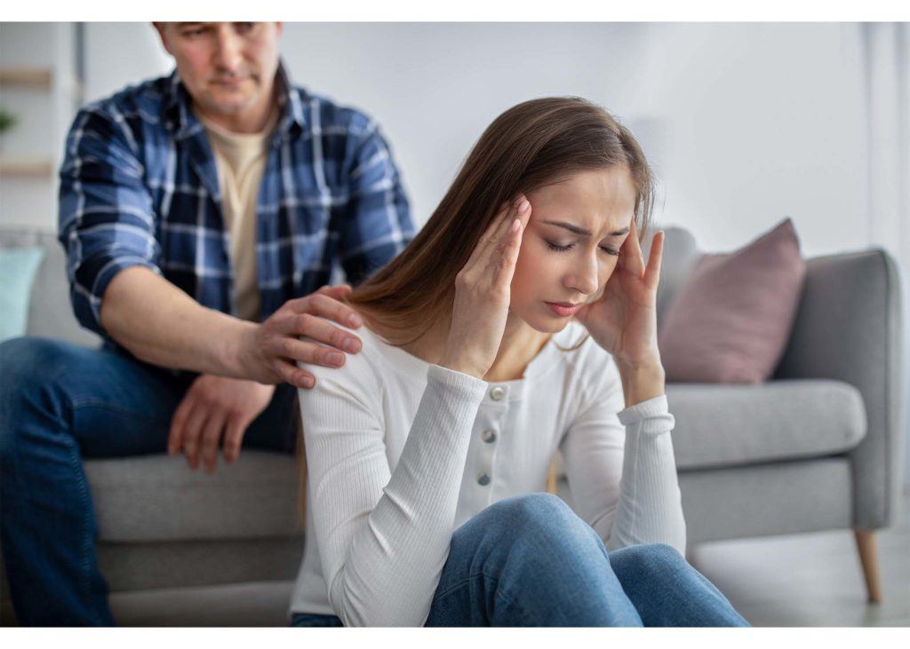 woman in distress comforted by spouse