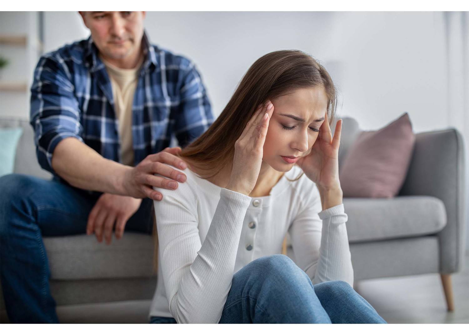 woman in distress comforted by spouse
