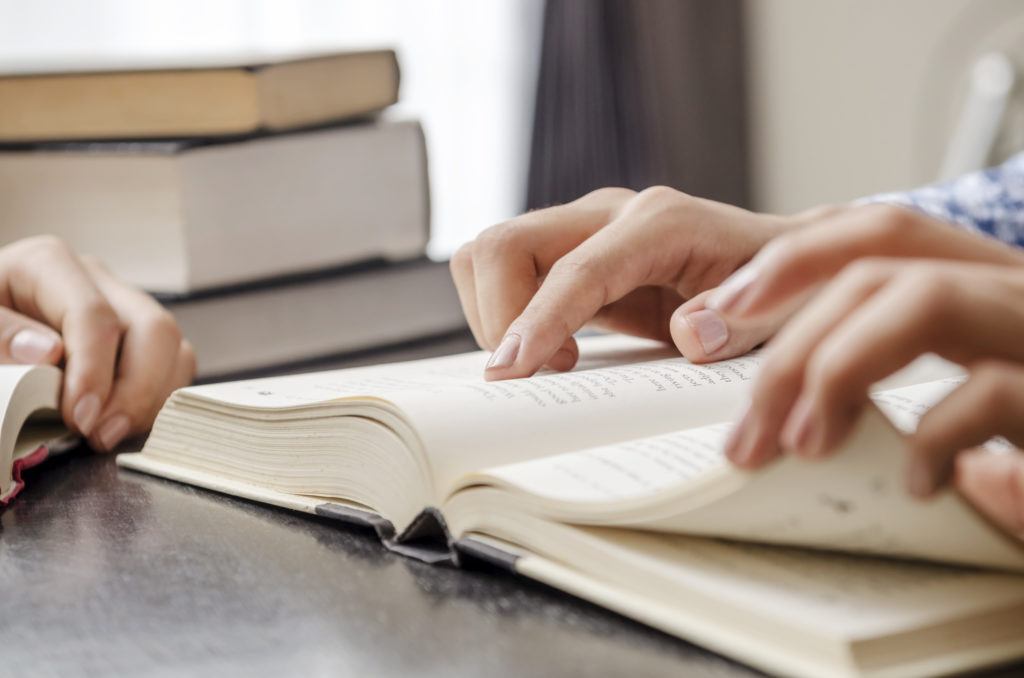 individuals looking through bible
